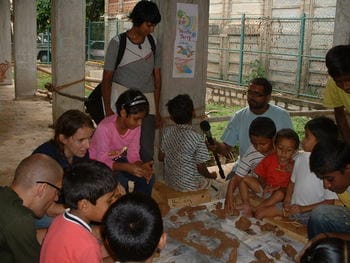 Kids modelling a clay village