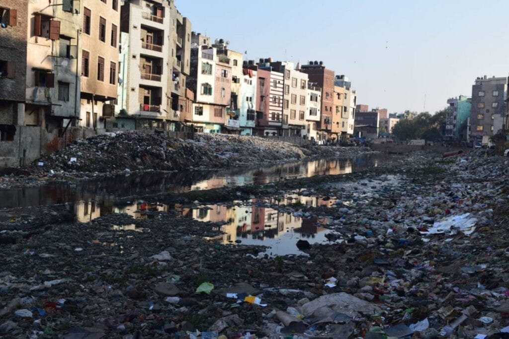 a view of seelampur that shows garbage and toxic waste