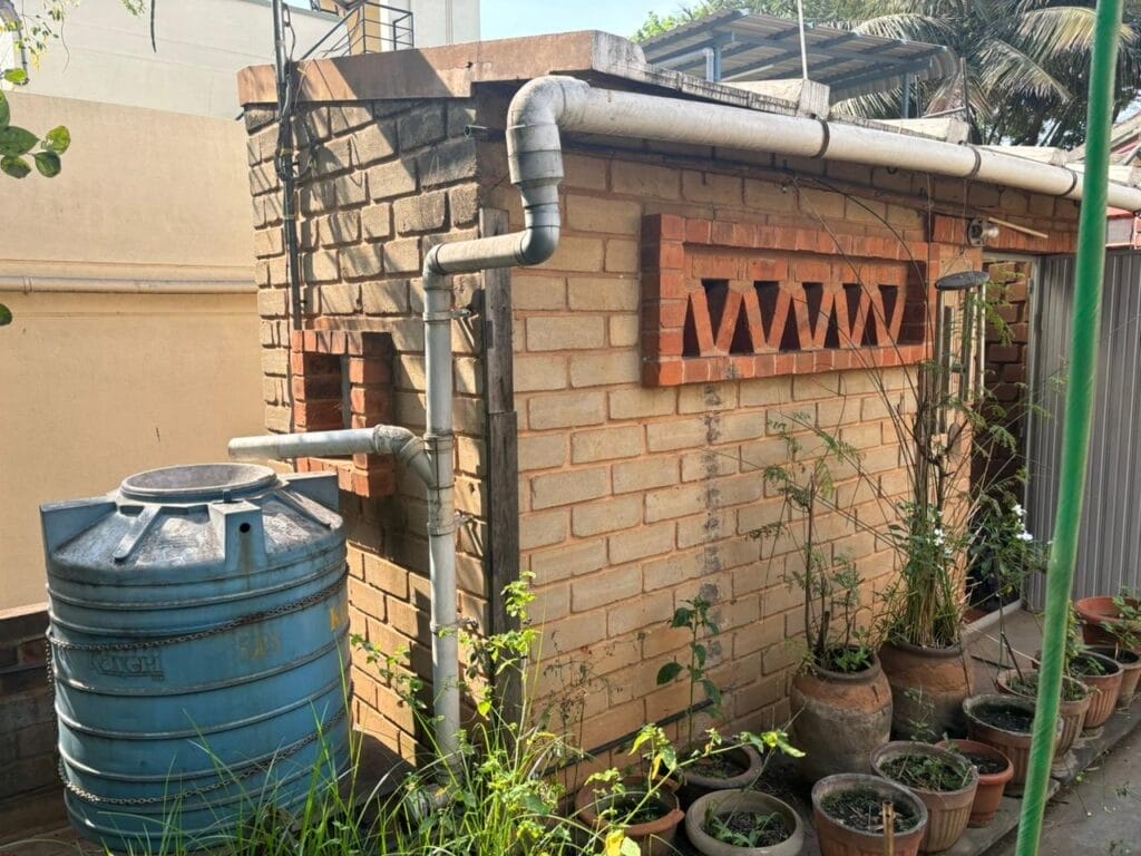 A simple rainwater harvesting system on the terrace connecting the staircase roof to a Rain Barrel.