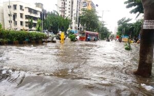 bus trying navigate as the road is flooded in mumbai