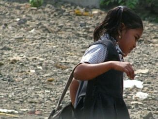 a school girl from Mumbai carries her bag to school