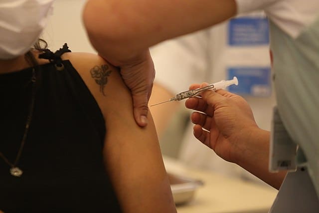 close up of a woman getting vaccinated