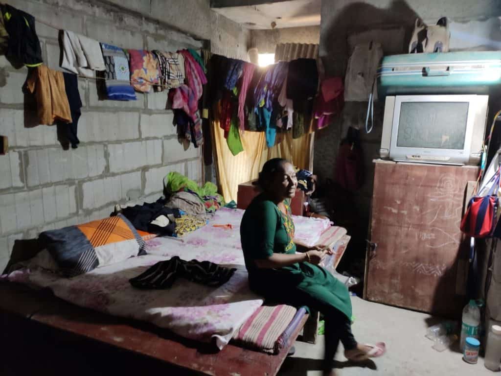 lady sitting in her husband's room at a construction site in Goregaon East