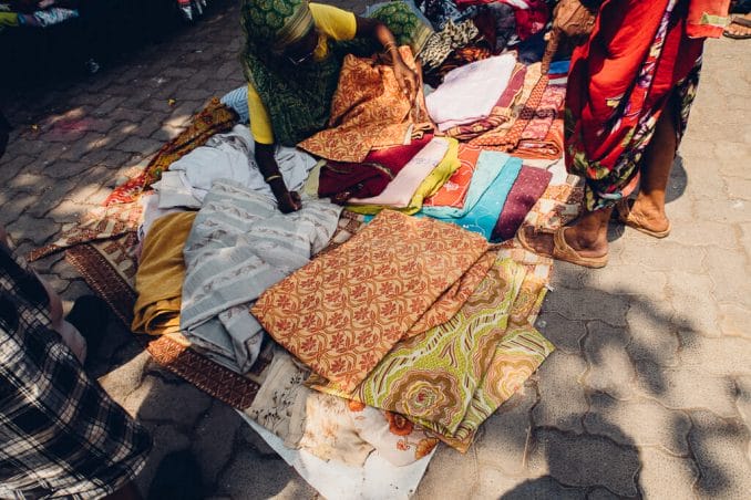 Street vendor selling clothes at a roadside shop.  Source: MS Gopal, Mumbai Paused