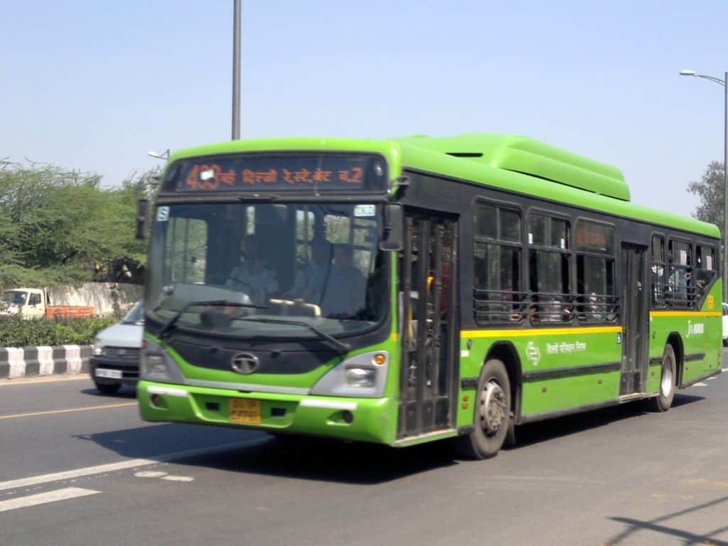A green, CNG bus in Delhi