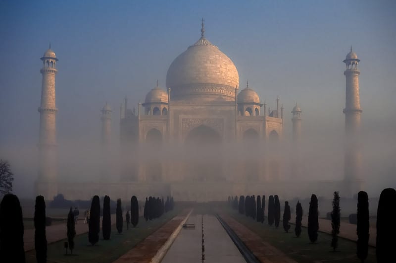 a layer of fog over the Taj Mahal in Agra, India