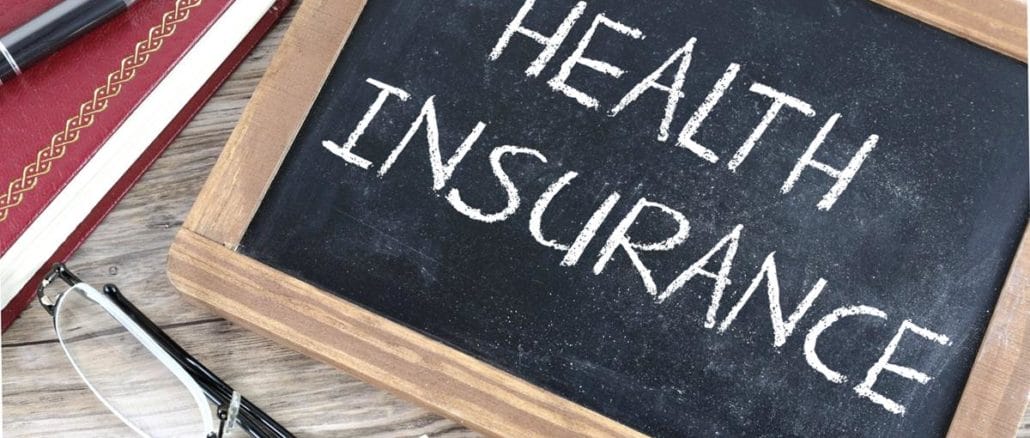 Representational image of a chalkboard with Health Insurance written on it.